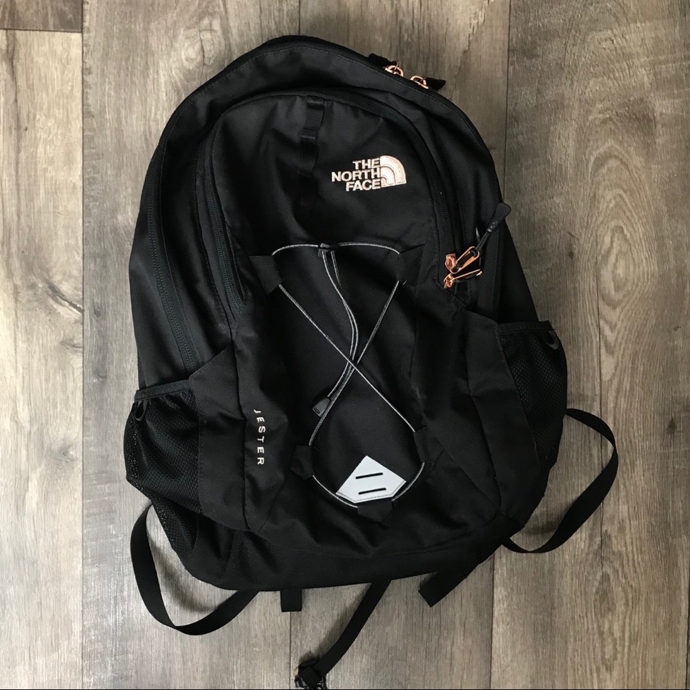 black and rose gold north face backpack